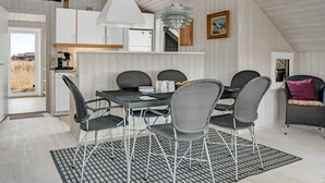 A modern kitchen with white cabinets, a white stove, and a hanging light fixture. - "Galmand" - 300m from the sea by Interhome (Lemvig)