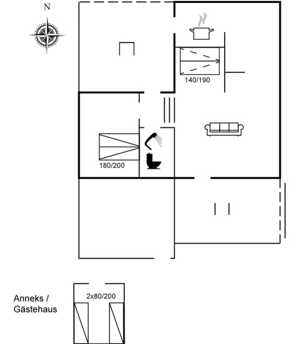 Ein Grundriss mit einer Küchenzeile, einem Badezimmer und einer Sitzecke.
