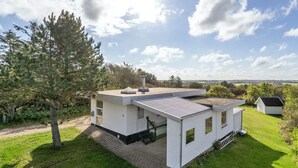 A modern single-story house with a flat roof, a chimney, and a small attached garage. - "Tomine" - 500m to the fjord by Interhome (Struer)