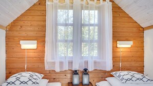 A cozy room with two beds, a wooden ceiling, and a large window with sheer curtains. - "Tomine" - 500m to the fjord by Interhome (Struer)