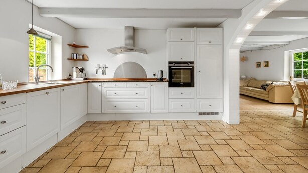 A spacious kitchen with white cabinetry, a built-in oven, and a herringbone-patterned floor. - "Wilmar" - 1km to the fjord by Interhome (Vemb)