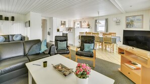 A modern living room with a sofa, chairs, a coffee table, and a TV. - "Elizabeth" - 400m to the fjord by Interhome (Ulfborg)