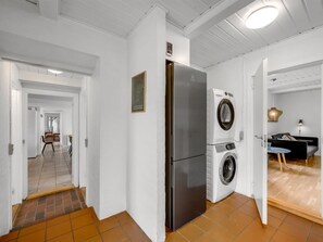 A modern kitchen with a stainless steel refrigerator and a front-loading washing machine. - "Cornelius" - 900m from the sea by Interhome (Ulfborg)