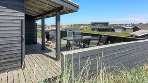 A wooden deck with outdoor furniture and a barbecue grill. - "Adelita" - 100m from the sea by Interhome (Løkken)