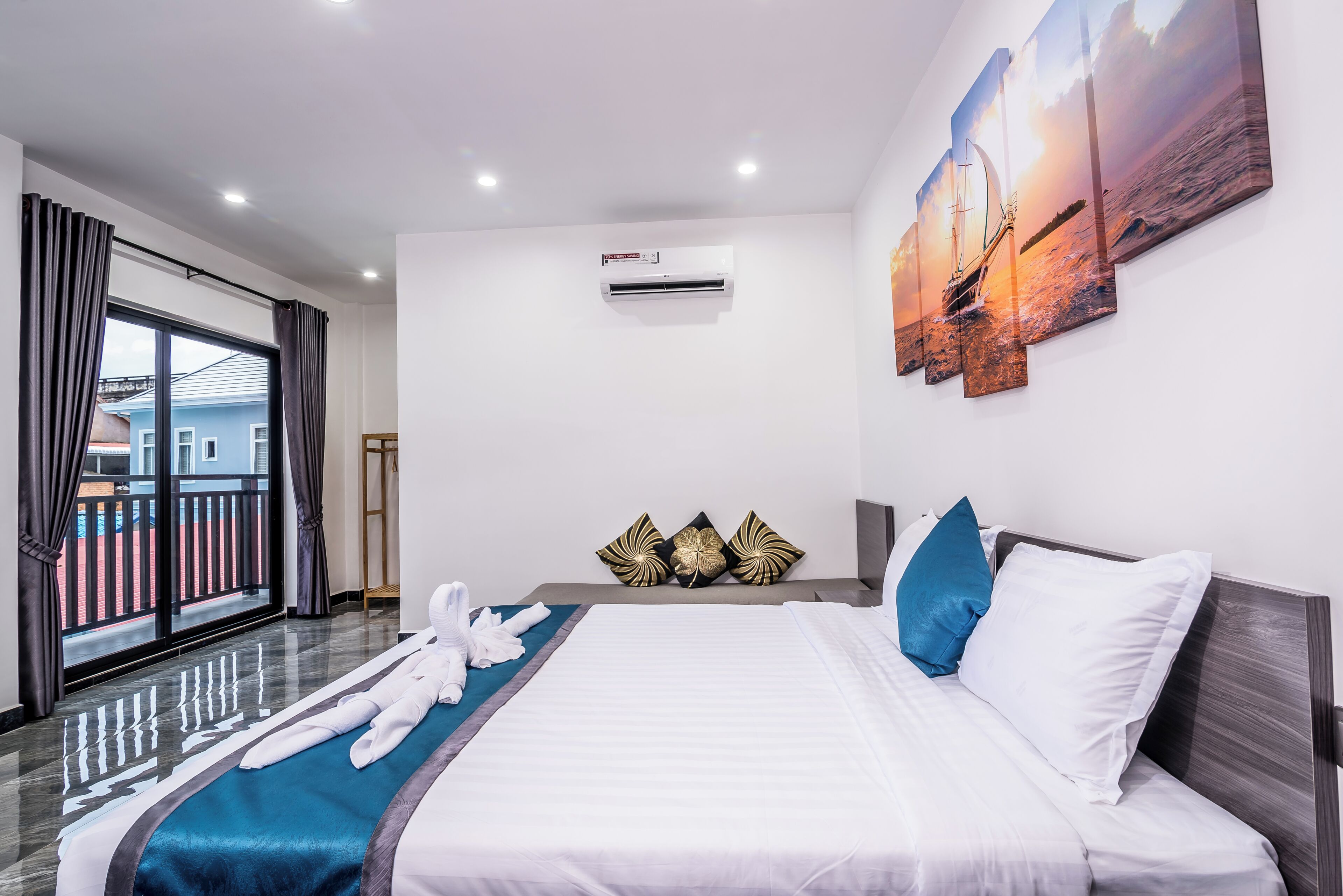 A hotel room with a bed, a view of the outside, and an air conditioning unit.