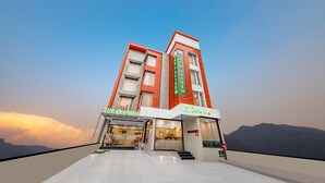 A modern building with a cafe named "The Classic" and a restaurant named "Cafe Classic". - The Classio By DLS Hotels (Narendranagar)
