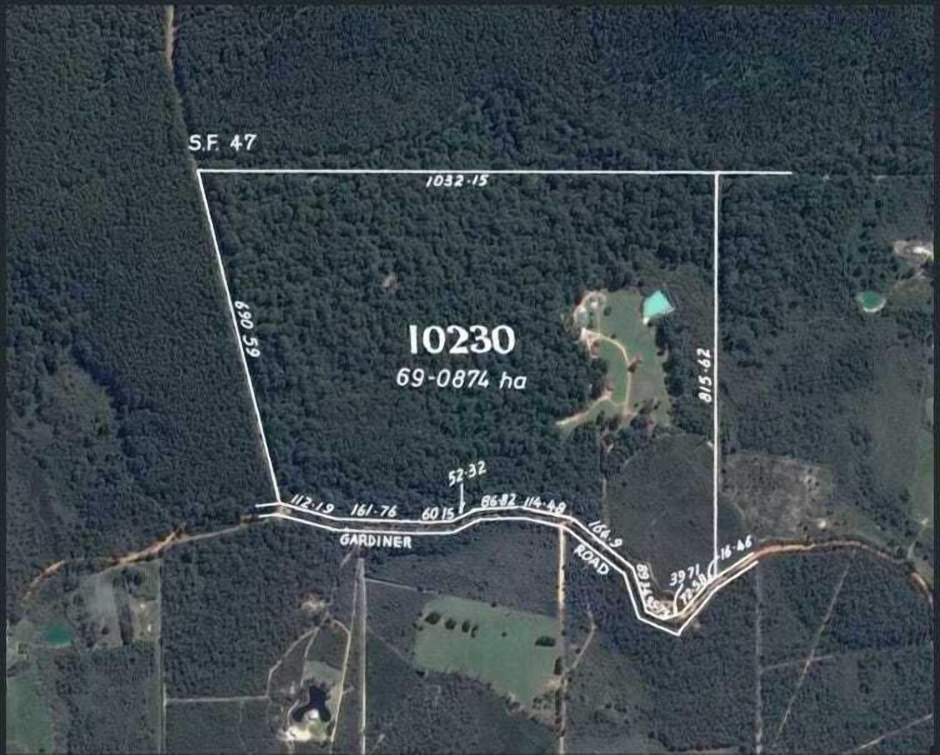 A satellite view of a property with a rectangular boundary, labeled "10230" and "69-0874 ha".