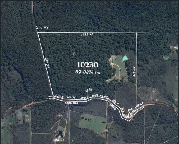 A satellite view of a property with a rectangular boundary, labeled "10230" and "69-0874 ha".