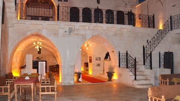 Experience the grandeur of this historic building with its arched doorways and ornate staircase.