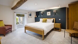 A bedroom with a bed, bedside tables, a chair, a wardrobe, and a window with curtains. - Joe's Cottage -  Modern, yet cosy, two bedroom cottage - Brigsteer (Brigsteer)