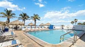 A pool area with lounge chairs and palm trees. - 3 Bedroom 2 Bath Beach View #205 Beach Place Condos (Madeira Beahc)