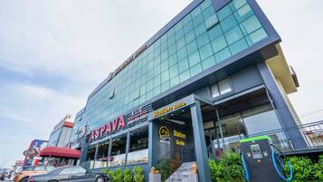 A modern hotel with a glass facade, a red awning, and a visible entrance to the Station Suite.