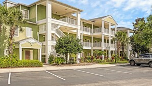 A multi-story hotel with balconies and a parking lot. - Mickey's Terrace at Bahama Bay (Davenport)