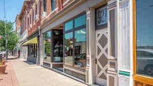 A row of brick buildings with large windows and a sidewalk. - Monmouth Lofts (Newport)