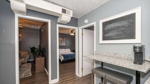 A modern kitchen with a built-in coffee maker, a bar stool, and a countertop. - Monmouth Lofts (Newport)