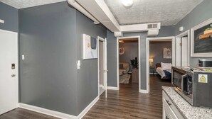 A modern kitchen with a microwave, a built-in oven, and a countertop. - Monmouth Loft 4 (Newport)