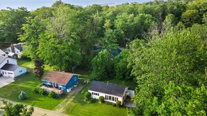 A residential area with houses surrounded by dense greenery and a view of the ocean. - Hemlock Hideout - 3 Mins from DT Lex, Great Beach! (Lexington Township)