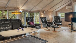 A modern living room with a wooden ceiling, leather sofas, a coffee table, and a TV. - "Vivan" - 3.8km from the sea by Interhome (Rømø)