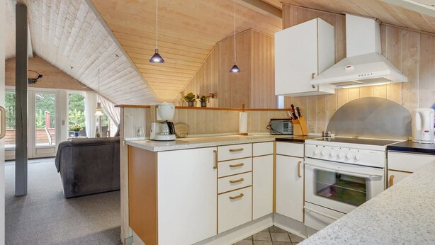 A modern kitchen with white cabinetry, a built-in oven, and a coffee maker. - "Runulf" - 2.9km from the sea by Interhome (Rømø)