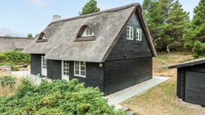A traditional house with a steep thatched roof, a small porch, and a window with a white frame. - "Risto" - 2.3km from the sea by Interhome (Rømø)