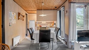 A modern kitchen with a dining area, wooden ceiling, and a large window. - "Falki" - 2.5km from the sea by Interhome (Rømø)