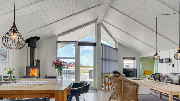 A spacious loft with a high ceiling, a fireplace, a dining area, and a living room with a television. - "Freek" - 400m from the sea by Interhome (Rømø)
