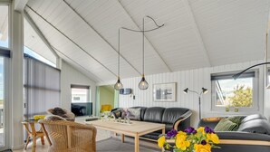 A modern living room with a sofa, a coffee table, and wicker chairs. - "Freek" - 400m from the sea by Interhome (Rømø)