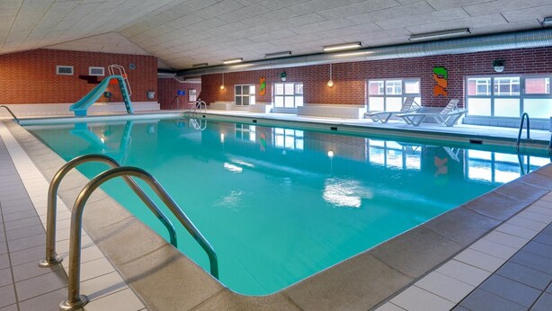 An indoor swimming pool with a slide, tiled floor, and brick walls. - "Mahena" - 2.3km from the sea by Interhome (Rømø)