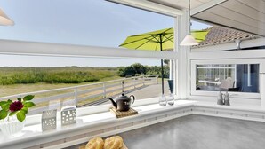 A modern interior with a large window overlooking a coastal landscape. - "Chrisse" - 550m from the sea by Interhome (Rømø)