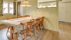 A dining area with a long wooden table, six chairs, and a hanging light fixture. - "Helline" - 900m from the sea by Interhome (Rømø)