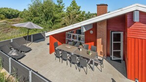 A patio with a table and chairs, a grill, and a covered seating area. - "Asdis" - 2.8km from the sea by Interhome (Rømø)