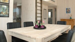 A dining area with a long table, black chairs, and a central decorative item. - "Tero" - 450m from the sea by Interhome (Vejers Strand)