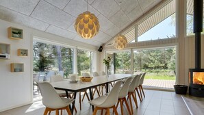 A modern dining area with a large table, white chairs, and pendant lights. - "Delan" - 1.3km from the sea by Interhome (Vejers Strand)