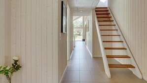 A hallway with wooden panel walls, a tiled floor, and a wooden staircase. - "Delan" - 1.3km from the sea by Interhome (Vejers Strand)