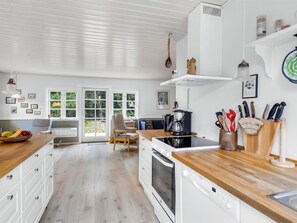 Kjøleskap, ovn, oppvaskmaskin og høy barnestol