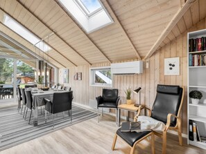 A modern interior with a dining area, seating, and a bookshelf. - "Anisette" - 1km from the sea by Interhome (Vejers Strand)