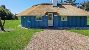 A blue house with a thatched roof, a chimney, and a gravel driveway. - "Kenny" - 1.2km from the sea by Interhome (Vejers Strand)