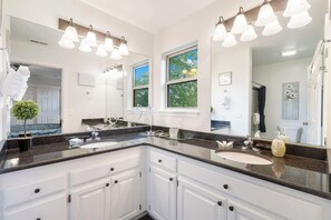 A modern bathroom with two sinks, large mirrors, and pendant lighting. - Retreat by Design - Resort Amenities (Branson West)