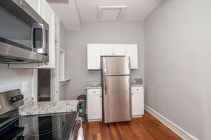 Condo, 1 Queen Bed, Kitchen | Private kitchen | Fridge, microwave, oven, stovetop - Suites on Main 3 (Covington)