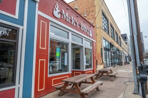 A red and blue storefront with a sign reading "Mck's BBQ". - The Heart of Madison 3 (Covington)