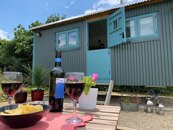 Enjoy a romantic evening with a bottle of wine and a view of the surrounding garden.