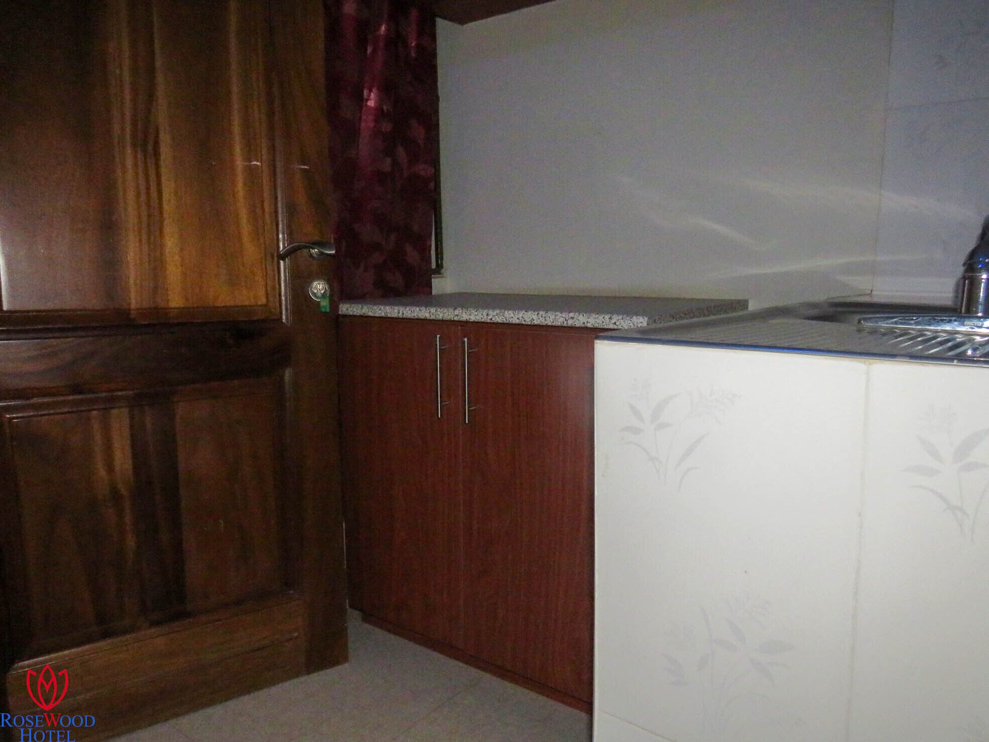A kitchen with wooden cabinets and a white countertop.