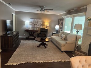 Relax in this inviting living room with a comfortable sofa, coffee table, and flat-screen TV.
