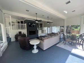Cozy living area with a fireplace, comfortable seating, and a dining space.