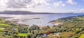 A coastal landscape with a lake, boats, and houses. - Luxury 5 Bedroom Home With Outdoor Jacuzzi and Indoor Sauna (Gorteanish)