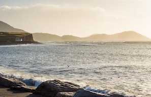 A coastal landscape with a lighthouse, rocky shoreline, and distant mountains. - Large House With Adjoining Cottage Close to Waterville (Waterville)