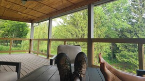 A wooden deck with a view of a forest. - Stay in the villa where the story's etched in stone  (Benton)