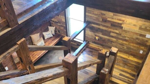A wooden staircase with a rustic design, leading to a higher level. - Stay in the villa where the story's etched in stone  (Benton)