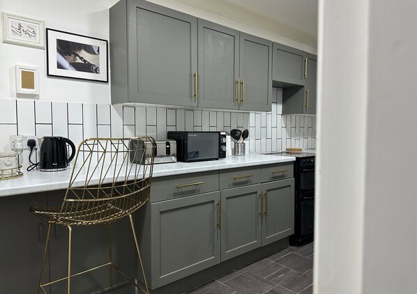 Enjoy cooking in this well-equipped kitchen with a microwave, coffee maker, and dishwasher.