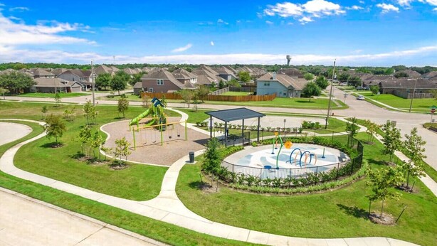 A playground with swings, a slide, and a circular play area with colorful equipment. - Home In The Heart Of Alvin! (Alvin)